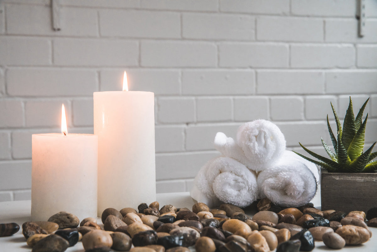 Ivory pillar candles on river stones