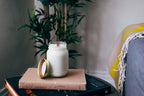 Rose Garden soy candle styled on a side table