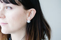 Double pearl earrings worn