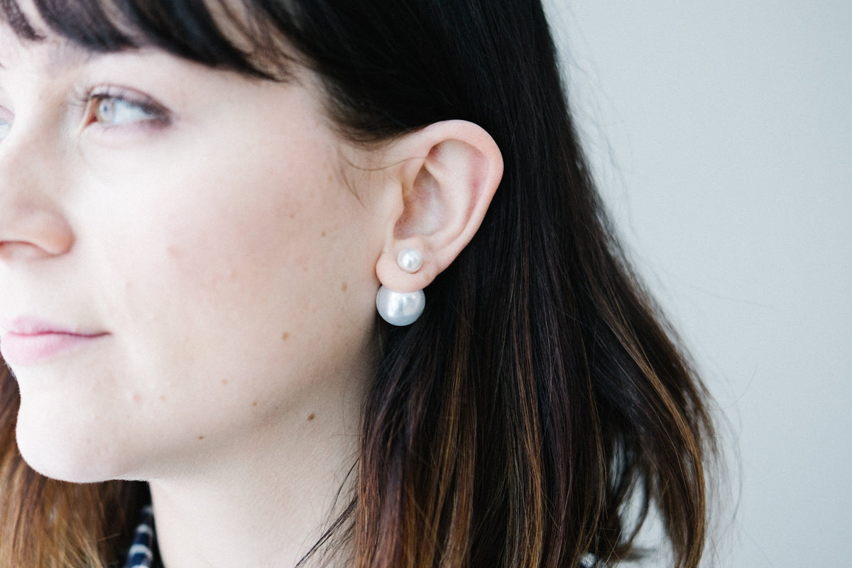 Double pearl earrings worn