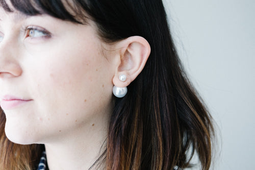 Double pearl earrings worn