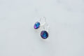 Galaxy glass drop earrings on marble