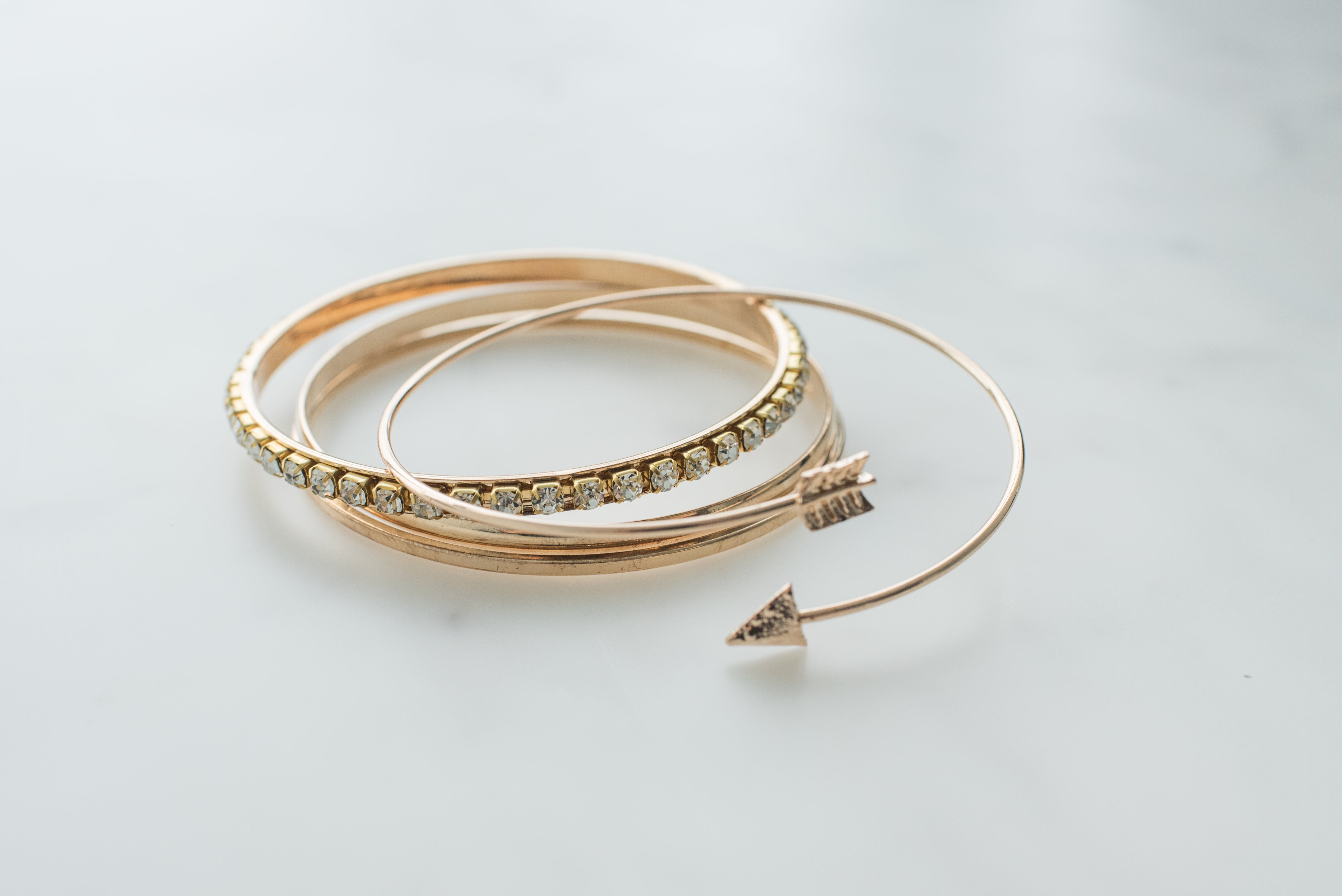 Handmade gold-tone bracelets on marble
